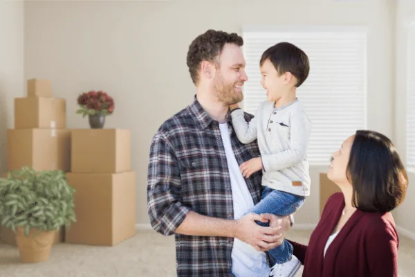 Happy family moving into their new Airdrie home